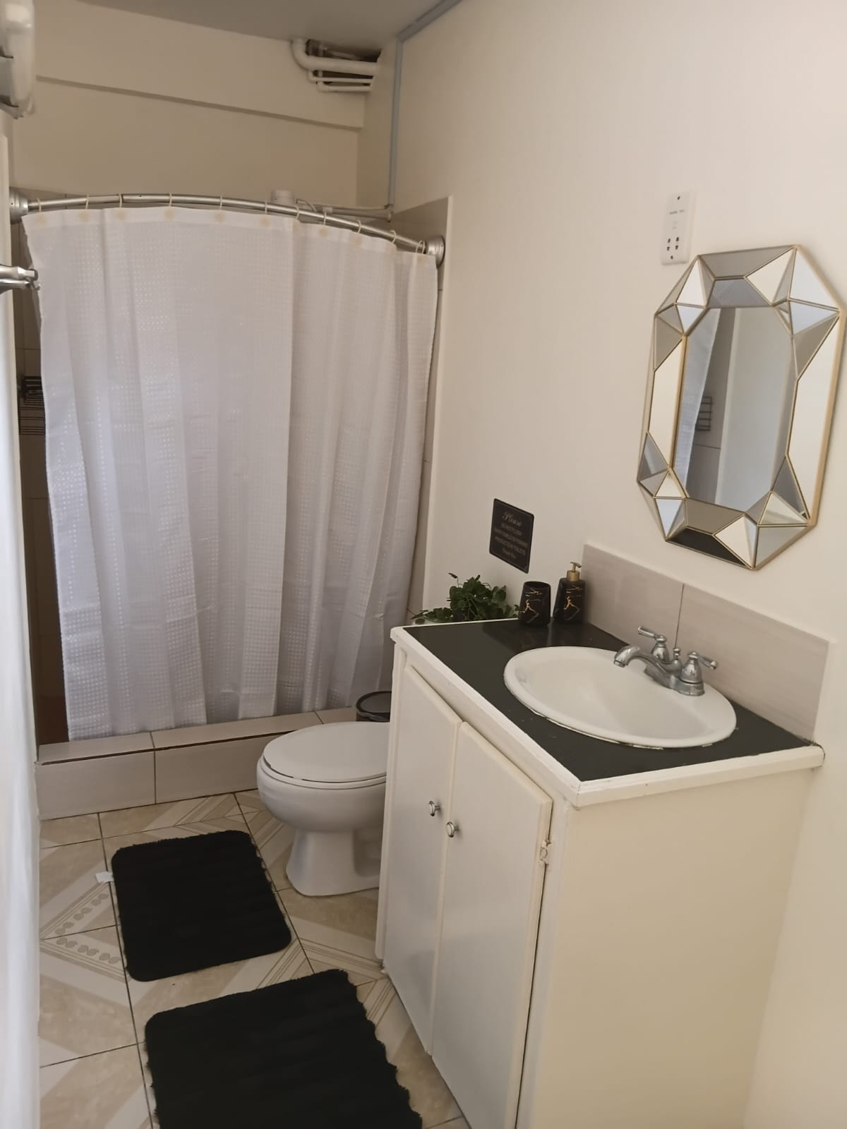 Bathroom with shower, vanity and mirror